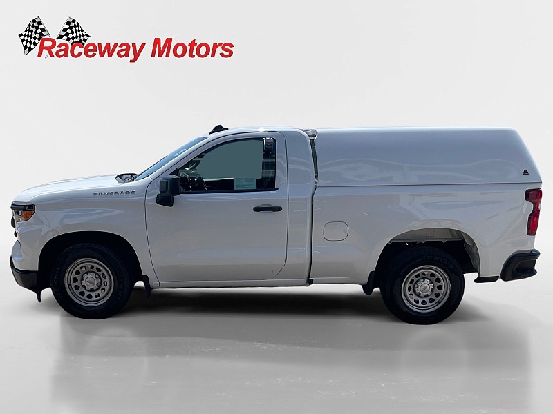 2023 Chevrolet Silverado 1500 2WD Regular Cab Work Truck in white, showcasing side view with Raceway Motors branding.