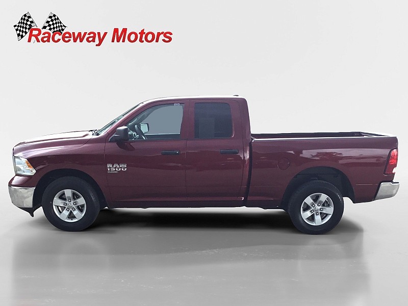 2024 Ram 1500 Classic 2WD SLT Quad Cab in burgundy, showcased by Raceway Motors, emphasizing its design and features for potential buyers.